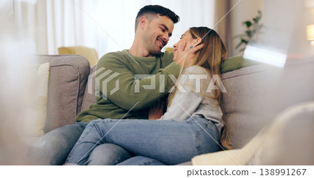 Happy couple, in love and together on sofa in living room for eye contact, trust or bonding. Man, woman and married with embrace for hug in romance, care or comfort in connection on honeymoon in home 138991267