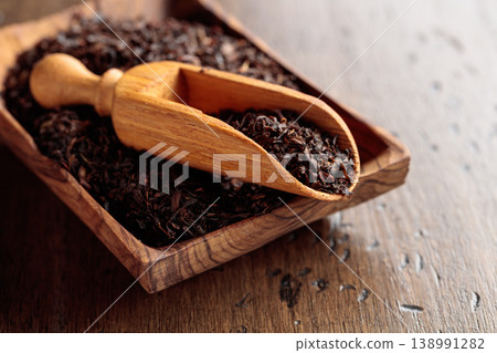 Black tea on an old wooden table. Black tea on an old wooden table. 138991282