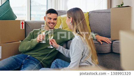 Couple, moving and home celebration with champagne drink at new property living room, boxes or future. Man, woman and wine glass as achievement happy or apartment change or milestone, cheers at sofa Couple, moving and home celebration with champagne drink at new property living room, boxes or future. Man, woman and wine glass as achievement happy or apartment change or milestone, cheers at sofa 138991320