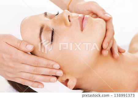 Head, hands and massage with a woman customer in studio isolated on a white background for stress relief. Spa, luxury face treatment and a young person at the salon for health, wellness or to relax 138991373