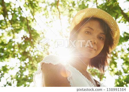 Portrait, trees or woman in park, countryside or natural environment to relax on summer break. Low angle, wellness or person in garden for peace or fresh air on an outdoor holiday vacation in nature 138991384
