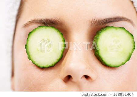 Woman, face and cucumber on eyes for wellness, cosmetic or spa therapy with closeup, relax and peace. Person, skincare or detox treatment for beauty, skin or stress relief and relaxation or wellbeing Woman, face and cucumber on eyes for wellness, cosmetic or spa therapy with closeup, relax and peace. Person, skincare or detox treatment for beauty, skin or stress relief and relaxation or wellbeing 138991404