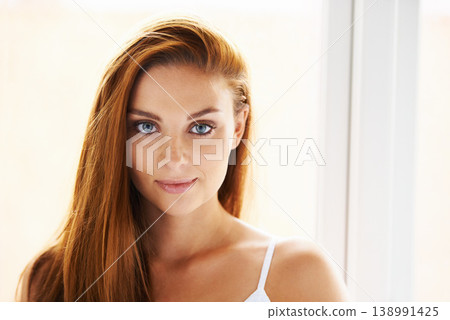 Hair care, portrait or happy woman by window with beauty, skincare or results for glow, shine or collagen. Smile, face or female model with cosmetics for treatment, healthy texture or growth in home Hair care, portrait or happy woman by window with beauty, skincare or results for glow, shine or collagen. Smile, face or female model with cosmetics for treatment, healthy texture or growth in home 138991425