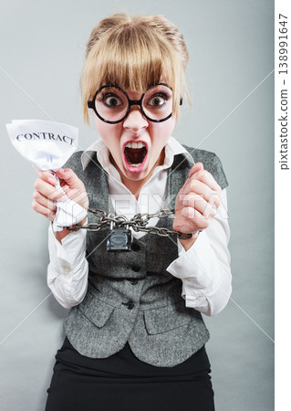 Furious woman with chained hands and contract Furious woman with chained hands and contract 138991647