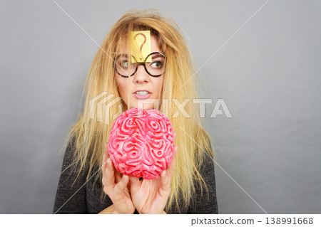 Weird woman holding brain having idea Weird woman holding brain having idea 138991668