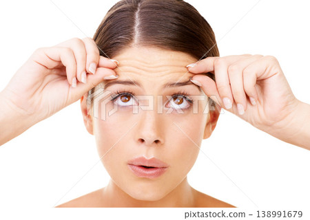 Skincare, stress and woman with forehead wrinkles check in studio for inspection on white background. Beauty, fail or female model with aging, anxiety or allergic reaction to cosmetics or treatment Skincare, stress and woman with forehead wrinkles check in studio for inspection on white background. Beauty, fail or female model with aging, anxiety or allergic reaction to cosmetics or treatment 138991679