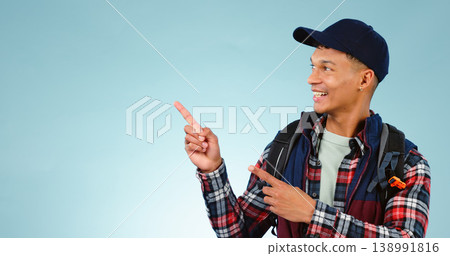 Happy, backpack and man in studio pointing for choice, decision and option on blue background. Travel, tourist mockup and isolated excited person with hand gesture for hiking, adventure and vacation Happy, backpack and man in studio pointing for choice, decision and option on blue background. Travel, tourist mockup and isolated excited person with hand gesture for hiking, adventure and vacation 138991816