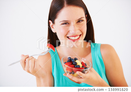 Health, happy and portrait of woman with fruit salad eating for nutrition, wellness and berry snack in studio. Food, diet and face of person for vitamins, detox and lose weight on white background Health, happy and portrait of woman with fruit salad eating for nutrition, wellness and berry snack in studio. Food, diet and face of person for vitamins, detox and lose weight on white background 138991820