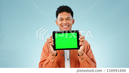 Portrait, smile and man with tablet, green screen and promotion on a blue studio background. Face, person and model with technology, internet and presentation with mockup space, news and digital app Portrait, smile and man with tablet, green screen and promotion on a blue studio background. Face, person and model with technology, internet and presentation with mockup space, news and digital app 138991886