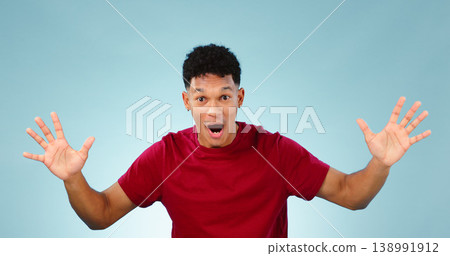Man, surprise and happy for prize, portrait or excited with face, good news and blue studio background. Energy, winning and wow for achievement, competition and hands for success, winner and offer Man, surprise and happy for prize, portrait or excited with face, good news and blue studio background. Energy, winning and wow for achievement, competition and hands for success, winner and offer 138991912