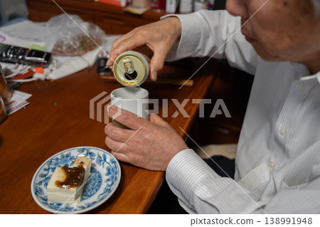 An elderly man drinking alcohol in the evening An elderly man drinking alcohol in the evening 138991948