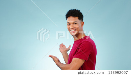 Portrait, happy man and smile with presentation in studio for promotion mockup on blue background. New York, male model and hand for show of announcement, offer and discount in space with gesture Portrait, happy man and smile with presentation in studio for promotion mockup on blue background. New York, male model and hand for show of announcement, offer and discount in space with gesture 138992097