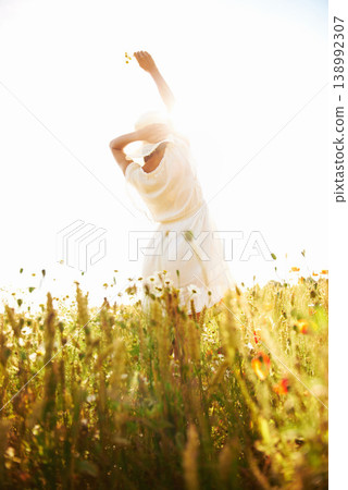 Freedom, back and woman at wheat field with flower in the countryside in summer, vacation or travel. Rear view, person in hat at farm or nature, garden or outdoor for stretching, lens flare or mockup Freedom, back and woman at wheat field with flower in the countryside in summer, vacation or travel. Rear view, person in hat at farm or nature, garden or outdoor for stretching, lens flare or mockup 138992307