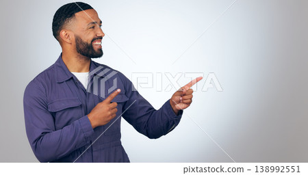 Happy man, pointing and mockup space for advertising or marketing against a studio background. Male person or salesman smile showing deal, list or information for advertisement, notification or alert Happy man, pointing and mockup space for advertising or marketing against a studio background. Male person or salesman smile showing deal, list or information for advertisement, notification or alert 138992551