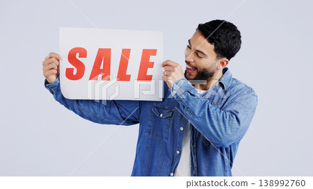 Man, sale and excited with board in studio mockup, shopping discount and advertising retail announcement. Young person, arab and marketing for deal promotion with product launch by white background Man, sale and excited with board in studio mockup, shopping discount and advertising retail announcement. Young person, arab and marketing for deal promotion with product launch by white background 138992760