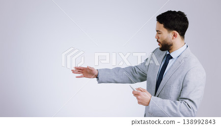 Business, presentation and space with a man training in studio on a gray background for marketing. Our vision, remote and information with a serious young corporate employee on mockup for advertising 138992843