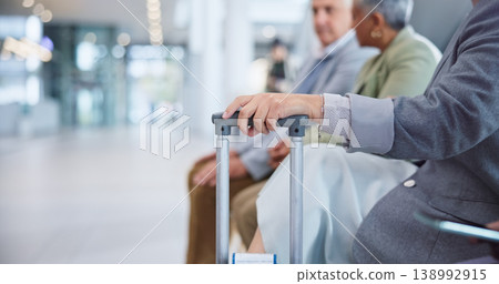 Hand, suitcase and a business person in the airport for travel, waiting to board his international flight. Corporate, luggage and a professional employee in a terminal or lobby for a global trip Hand, suitcase and a business person in the airport for travel, waiting to board his international flight. Corporate, luggage and a professional employee in a terminal or lobby for a global trip 138992915