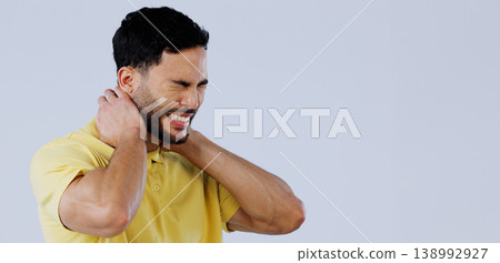 Neck pain, stress and man in studio at space with tired joints, arthritis risk or burnout on white background. Indian model, injury and massage muscle for first aid, emergency or frustrated at mockup Neck pain, stress and man in studio at space with tired joints, arthritis risk or burnout on white background. Indian model, injury and massage muscle for first aid, emergency or frustrated at mockup 138992927