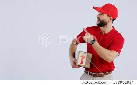 Man, courier and pointing with delivery in studio with mock up for offer on white background in Mexico. Male model, hand and gesture for announcement, promotion or notification in space for logistics Man, courier and pointing with delivery in studio with mock up for offer on white background in Mexico. Male model, hand and gesture for announcement, promotion or notification in space for logistics 138992934
