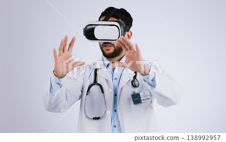 Doctor, vision and virtual reality glasses for medical software, metaverse, futuristic technology and digital experience in studio. Healthcare man with 3d exam, hands and VR on a white background Doctor, vision and virtual reality glasses for medical software, metaverse, futuristic technology and digital experience in studio. Healthcare man with 3d exam, hands and VR on a white background 138992957