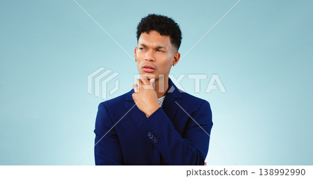 Man, thinking with idea in studio or decision and planning problem solving by blue background. Young, brazil and person in thought for creative solution, project insight and choice by mock up space Man, thinking with idea in studio or decision and planning problem solving by blue background. Young, brazil and person in thought for creative solution, project insight and choice by mock up space 138992990