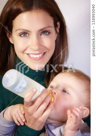 Woman, face and baby for feeding by bottle for hunger, nutrition and care with milk in home. Happy mother, infant and love for child growth, development or milestone with formula for healthy diet 138993040