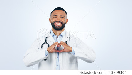 Portrait, doctor with heart hands and smile in studio for care, kindness and trust icon in healthcare. Support, love emoji and help medical professional man showing happiness on white background. 138993041