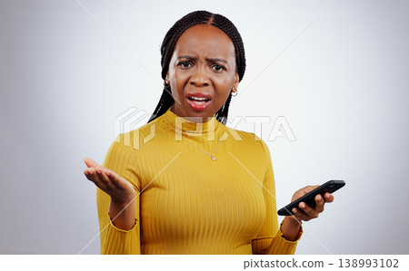 Phone text, black woman and confused portrait from scam conversation and anxiety from problem and fail. Studio, white background and frustrated female person with spam communication and mistake Phone text, black woman and confused portrait from scam conversation and anxiety from problem and fail. Studio, white background and frustrated female person with spam communication and mistake 138993102