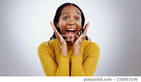 Wow, news and hands on face of black woman in studio happy with competition, prize or bonus on grey background. Surprise, omg or portrait of African lady winner with mind blown emoji or lotto results Wow, news and hands on face of black woman in studio happy with competition, prize or bonus on grey background. Surprise, omg or portrait of African lady winner with mind blown emoji or lotto results 138993106