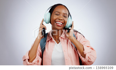 Music, student or happy black woman in studio listening to radio playlist to relax on grey background. Face, headphones or African person with smile singing or streaming a song audio or sound track Music, student or happy black woman in studio listening to radio playlist to relax on grey background. Face, headphones or African person with smile singing or streaming a song audio or sound track 138993109