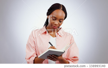 Woman, notebook and writing ideas, planning or creative solution for studying, college or education goals in studio. African student with book reminder and notes for learning or future plan in studio Woman, notebook and writing ideas, planning or creative solution for studying, college or education goals in studio. African student with book reminder and notes for learning or future plan in studio 138993140