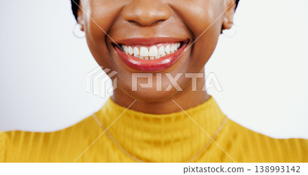 Teeth whitening, smile and black woman with mouth closeup for beauty or dental happiness in studio white background. African, lips and wellness from dentist, healthcare and veneers or orthodontics Teeth whitening, smile and black woman with mouth closeup for beauty or dental happiness in studio white background. African, lips and wellness from dentist, healthcare and veneers or orthodontics 138993142