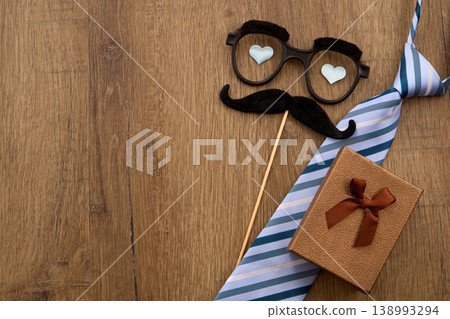 Father's day celebration with tie, gift, and mustache glasses Father's day celebration with tie, gift, and mustache glasses 138993294
