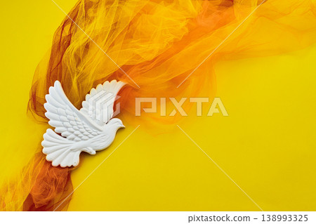Pentecost. White dove symbol flying with orange light and hope Pentecost. White dove symbol flying with orange light and hope 138993325