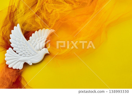 Pentecost. White dove representing peace flying with orange fabric Pentecost. White dove representing peace flying with orange fabric 138993330