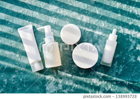 Skincare product packaging on green velvet with shadows Skincare product packaging on green velvet with shadows 138993728