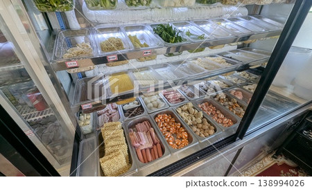 Noodles and ingredients lined up in the refrigerated display case of a Mala Tang restaurant. Noodles and ingredients lined up in the refrigerated display case of a Mala Tang restaurant. 138994026