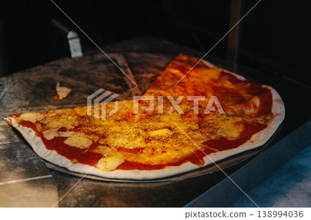 Delicious pizza Margarita in a traditional Italian pizzeria. 138994036