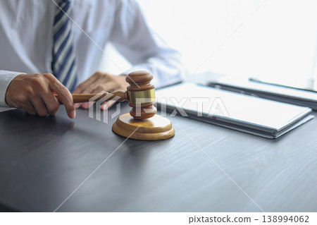 Lawyer Reviewing Contract and Documents with Gavel on Desk. Lawyer Reviewing Contract and Documents with Gavel on Desk. 138994062