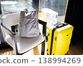 Backpack and yellow suitcase ready for travel near window indoors 138994269