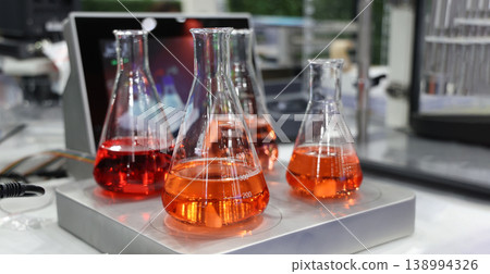 Sciene laboratory. Close up of Modern laboratory scenes with glassware tube reactors and colorful liquids in testing and analysis processes. Chemistry research pharmaceuticals biotechnology concepts. Sciene laboratory. Close up of Modern laboratory scenes with glassware tube reactors and colorful liquids in testing and analysis processes. Chemistry research pharmaceuticals biotechnology concepts. 138994326