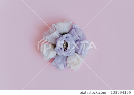 Beautiful white and purple Eustoma (Lisianthus) flowers on a pink pastel background. Beautiful white and purple Eustoma (Lisianthus) flowers on a pink pastel background. 138994399