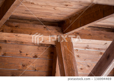 Close-up of rustic wooden beams in attic structure 138994469