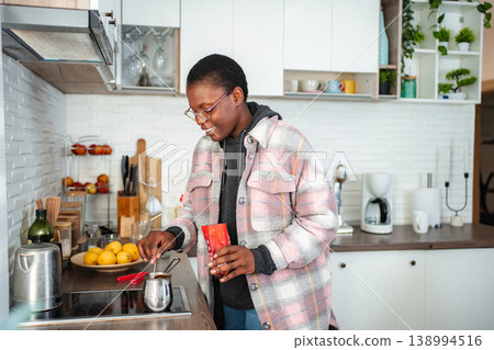 Woman making coffee in kitchen in the morning Woman making coffee in kitchen in the morning 138994516