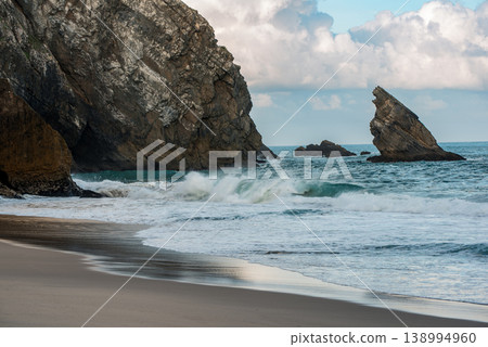 Praia da Adraga Coastal Archway in Sintra Portugal, beautiful beach with rocks in the sea ocean Praia da Adraga Coastal Archway in Sintra Portugal, beautiful beach with rocks in the sea ocean 138994960