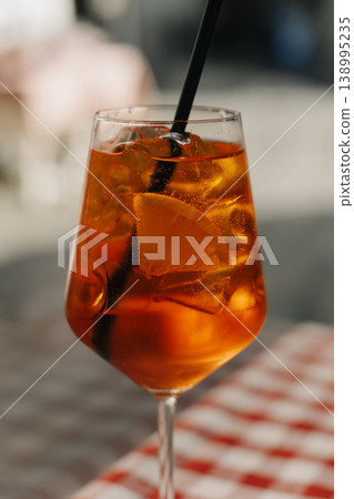 Glass with cocktail on the table in a traditional Italian restaurant. Glass with cocktail on the table in a traditional Italian restaurant. 138995235