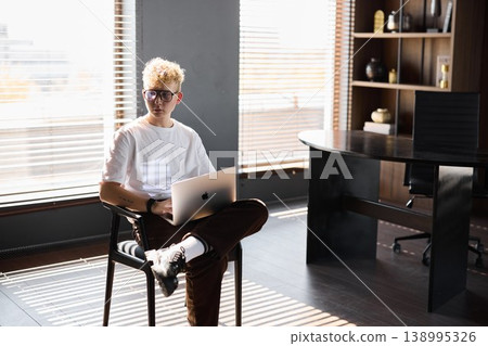 Young person seated casually reviewing slides with style 138995326