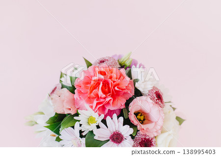 Beautiful bouquet of pink. violet and white flowers on a pink pastel background. Beautiful bouquet of pink. violet and white flowers on a pink pastel background. 138995403