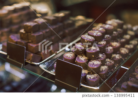 Delicious candies on a plate in a chocolate shop. Delicious candies on a plate in a chocolate shop. 138995411