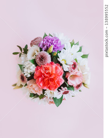 Beautiful bouquet of pink. violet and white flowers on a pink pastel background. 138995552